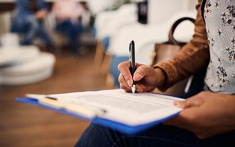 Patient filling out paperwork in lobby