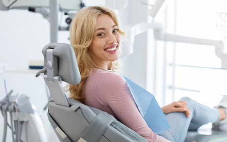 Patient smiling while sitting in treatment chair