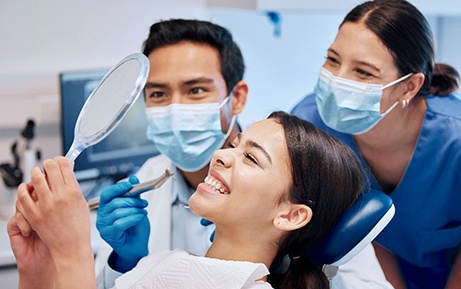 Patient in Clearwater smiling at dentist after getting dental implants