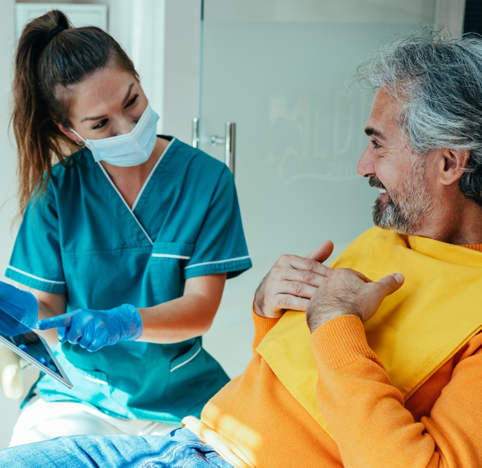 Dentist showing a patient a tablet screen in a dental office in Clearwater