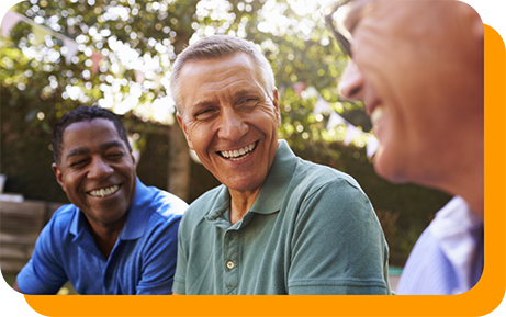 Three men laughing together outdoors