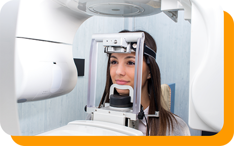 Dental patient getting a cone beam C T scan of her mouth and jaws