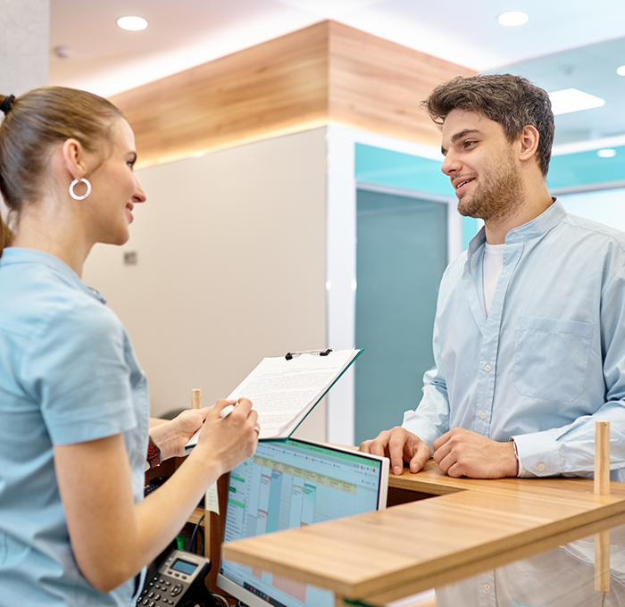 Man checking in at front desk of dental office in Clearwater