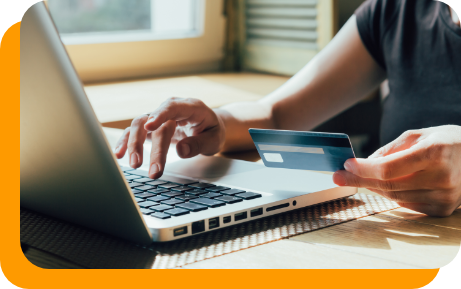 Person entering their payment card information onto a laptop