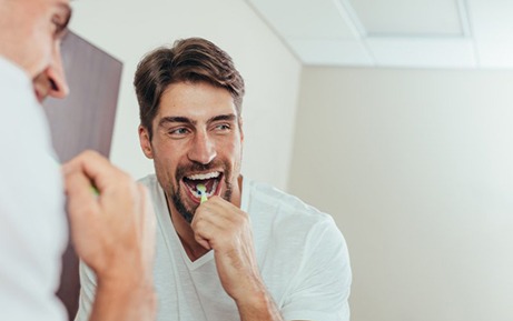 a man brushing his teeth in the morning