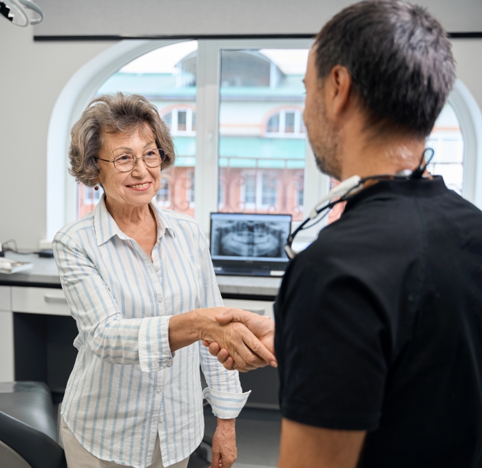 Senior woman shaking hands with her dentist in Clearwater