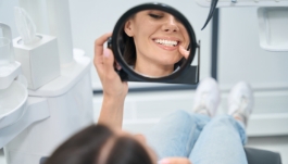 Dental patient looking at her smile in a mirror