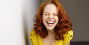 Woman with curly red hair laughing