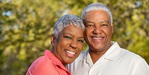 Older man and woman smiling together outdoors