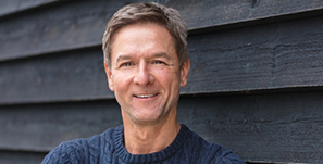 Smiling man in dark blue sweater