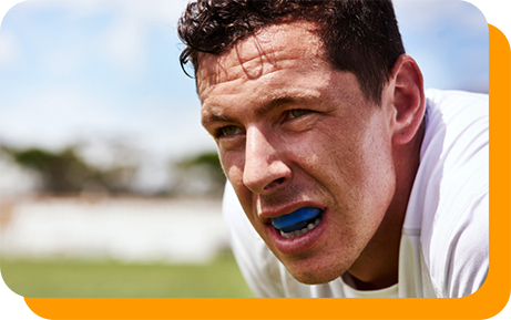 Man wearing a blue mouthguard over his teeth