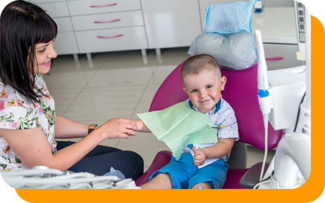 Young boy giving a thumbs up in the dental chair