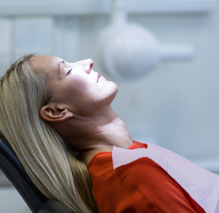 Woman relaxing in dental chair thanks to sedation dentistry in Clearwater