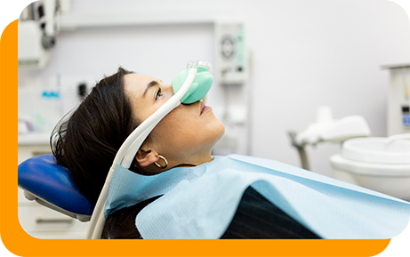 Woman in dental chair with nitrous oxide mask over her nose