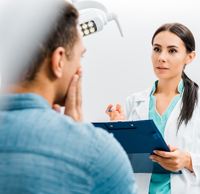 Person talking to their dentist about tooth extractions in Clearwater